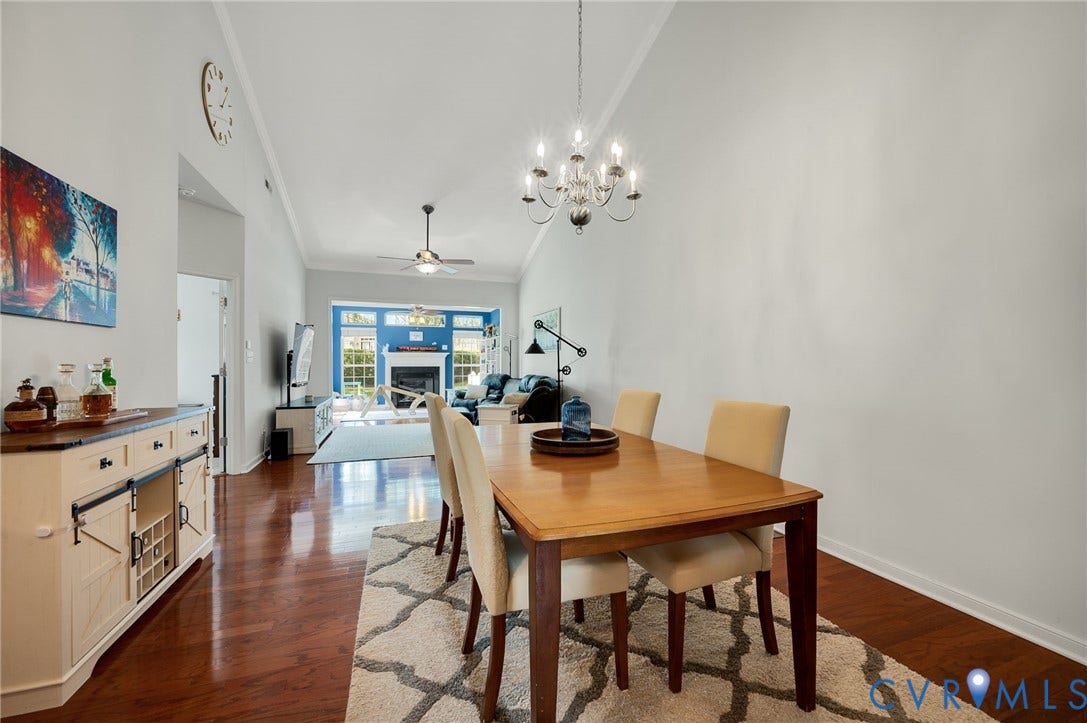 2811 Murano Way, The Villas At Hunton Park, Glen Allen, VA 23059 Open-concept living space featuring wood-finish flooring, a vaulted ceiling, and a chandelier
