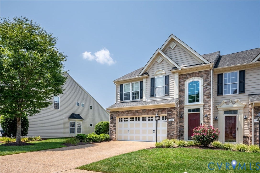 2811 Murano Way, The Villas At Hunton Park, Glen Allen, VA 23059 Stone and siding facade featuring a prominent arched window, two-car garage, and landscaped front yard