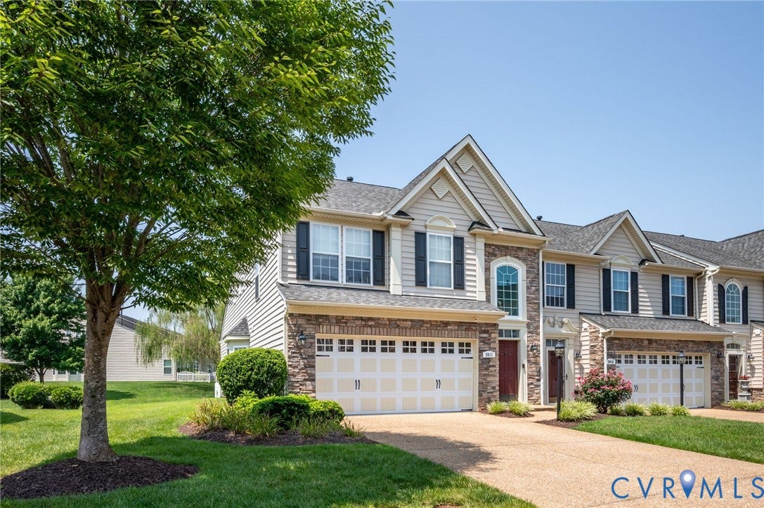 2811 Murano Way, The Villas At Hunton Park, Glen Allen, VA 23059 Elegant two-story Colonial featuring a mixed-material exterior with stone accents, multi-pane windows with dark shutters, and a peaked roofline with gabled dormers