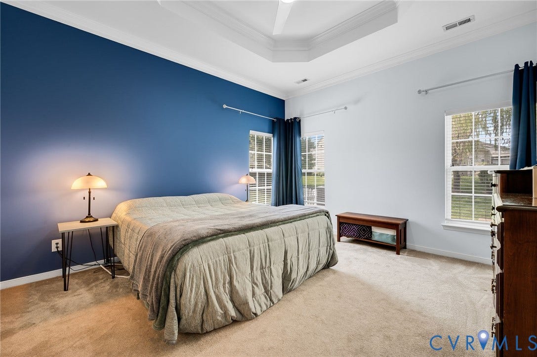 2811 Murano Way, The Villas At Hunton Park, Glen Allen, VA 23059 Tray ceiling with crown molding, carpeted flooring, two windows with blinds, and a built-in wall niche
