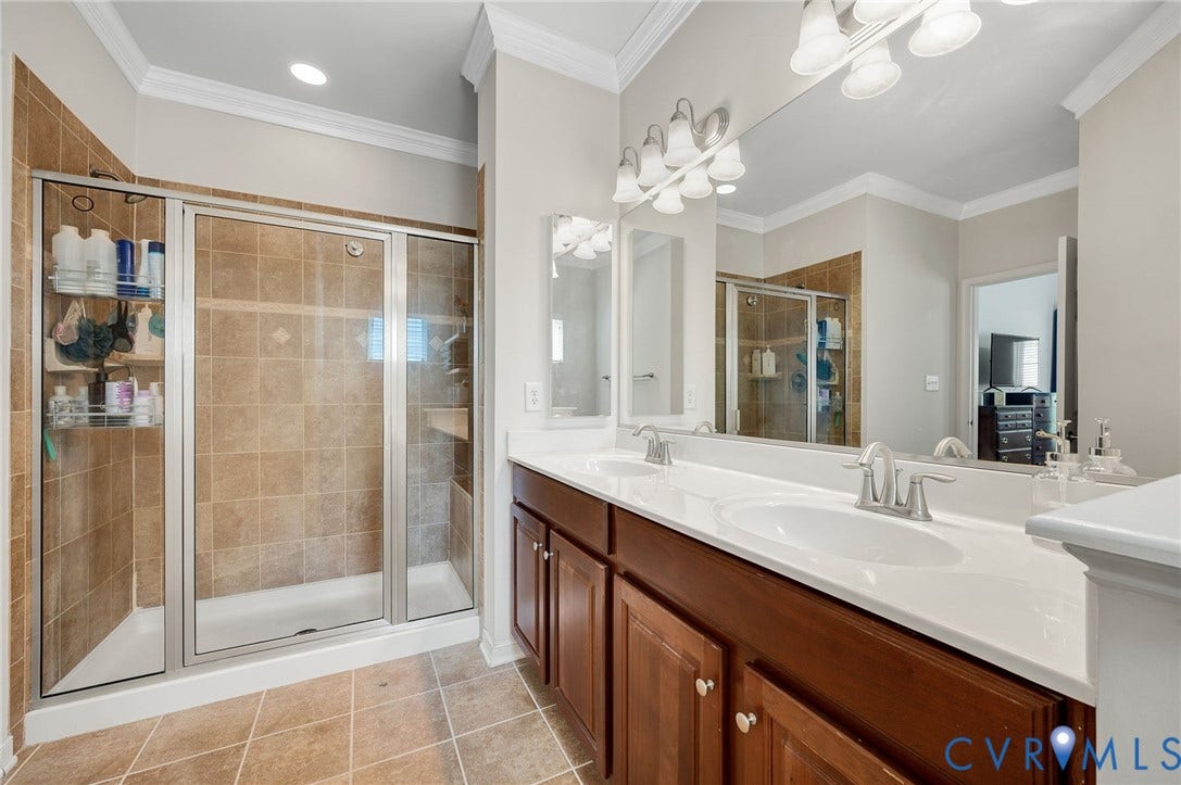 2811 Murano Way, The Villas At Hunton Park, Glen Allen, VA 23059 Spa-inspired primary bathroom featuring dual vanities with white quartz countertops, wood-finish cabinetry, and brushed nickel hardware