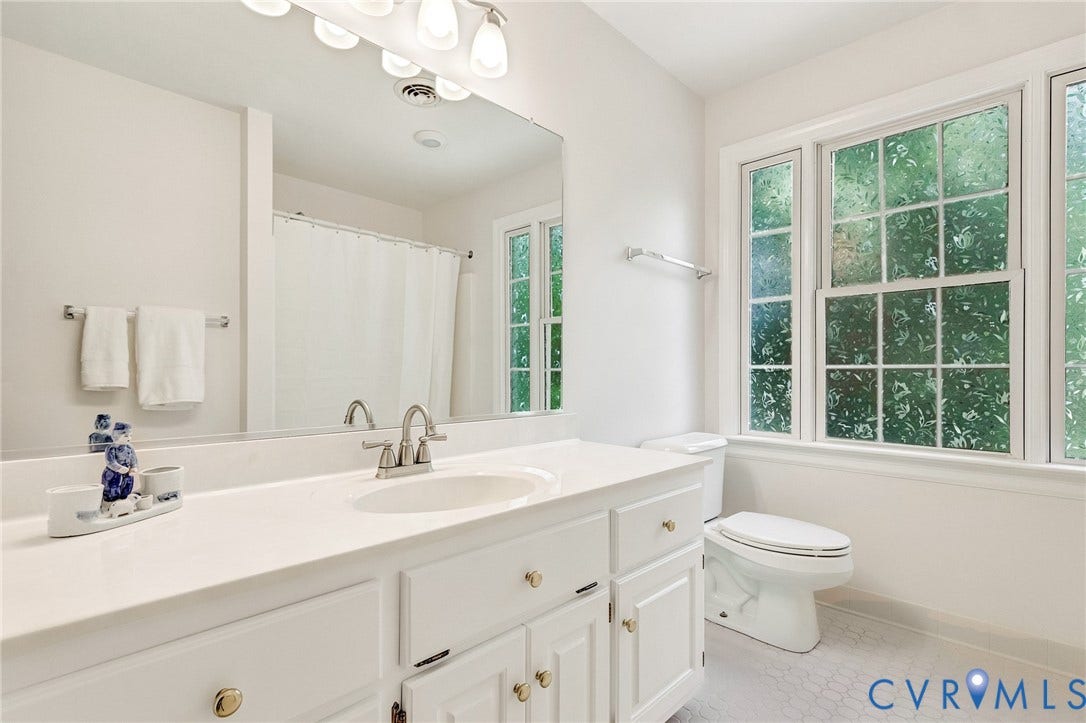 16406 Inchcape Road, Chesterfield, VA 23120 Vanity with a single basin sink, white cabinetry with brass hardware, and a large wall-mounted mirror