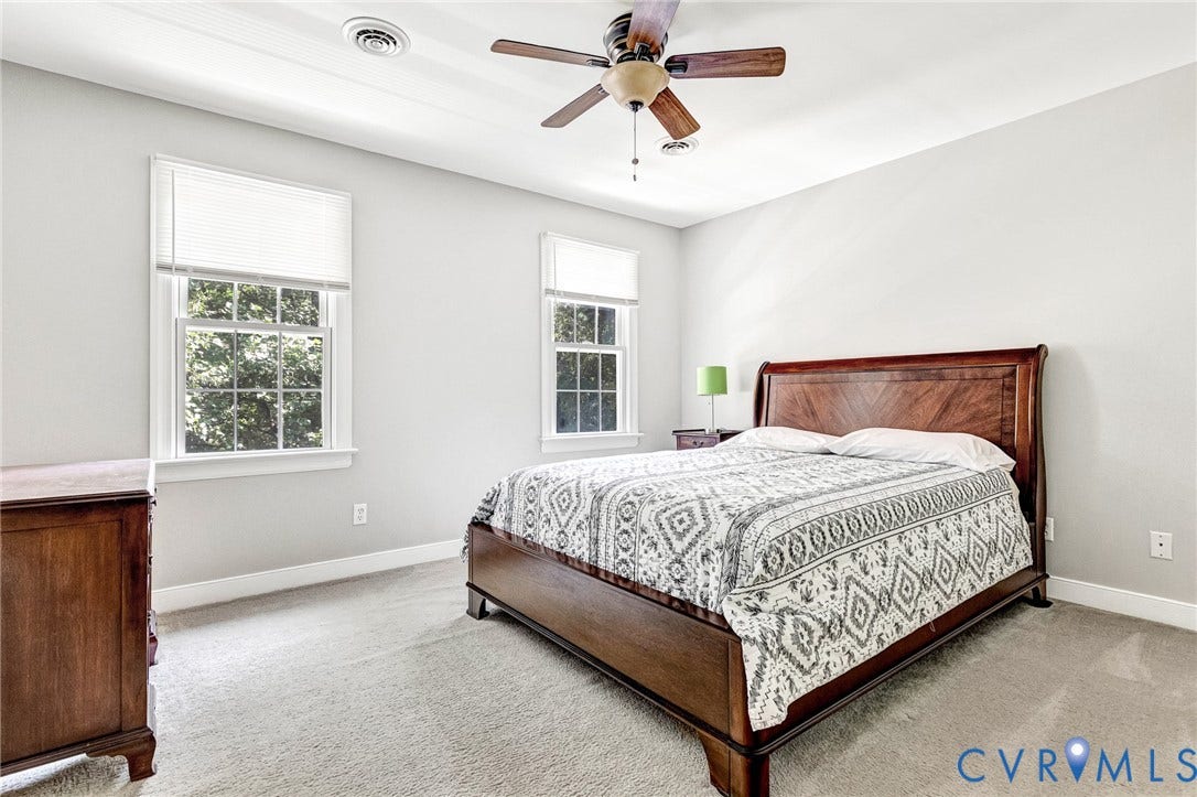 16406 Inchcape Road, Chesterfield, VA 23120 Light-toned walls, two double-hung windows, and a ceiling fan with integrated lighting