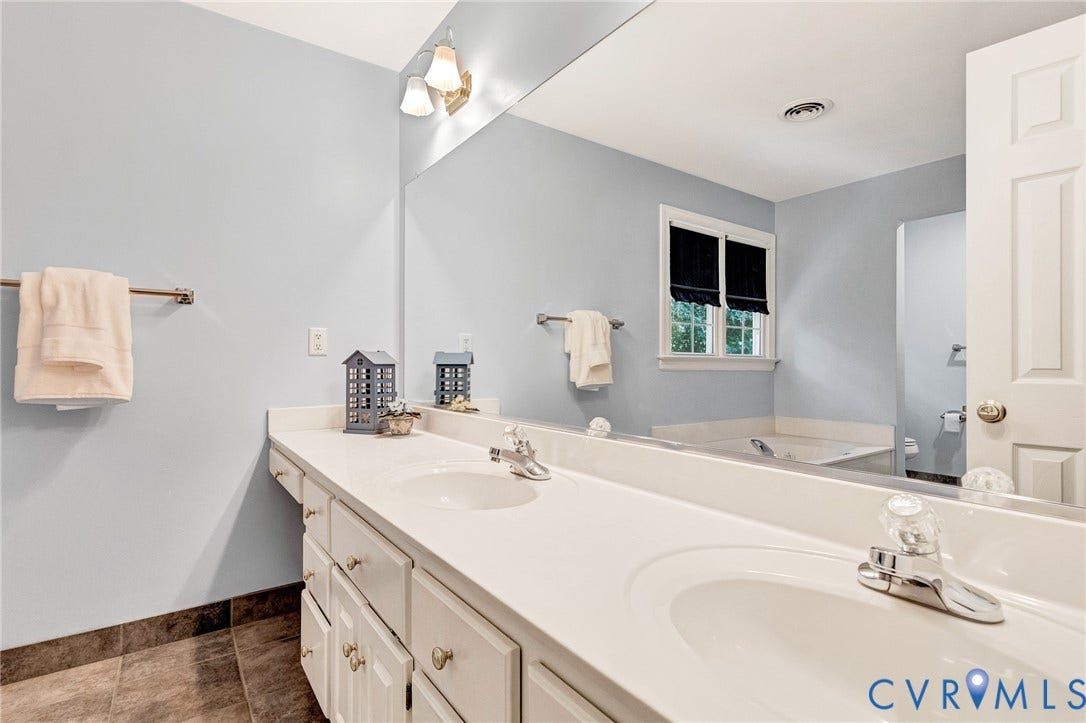 16406 Inchcape Road, Chesterfield, VA 23120 Dual vanity with white cabinetry, integrated sinks, white countertops, and chrome fixtures