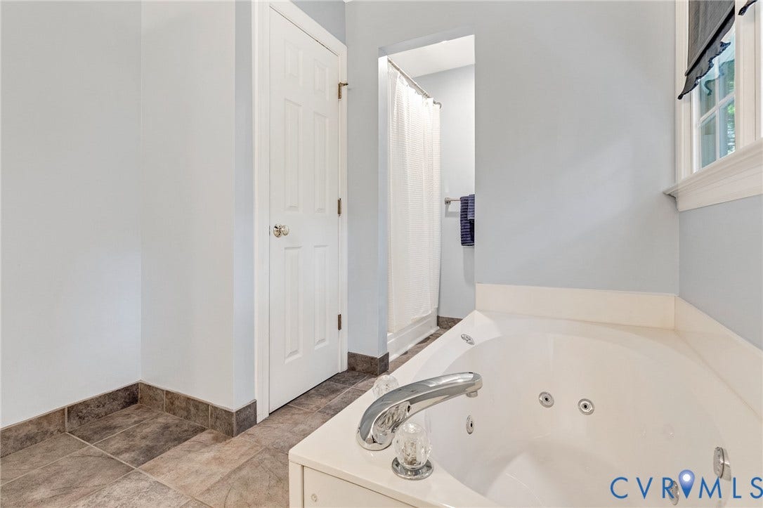 16406 Inchcape Road, Chesterfield, VA 23120 Corner jetted soaking tub with chrome fixtures, tiled flooring, and a separate shower enclosure