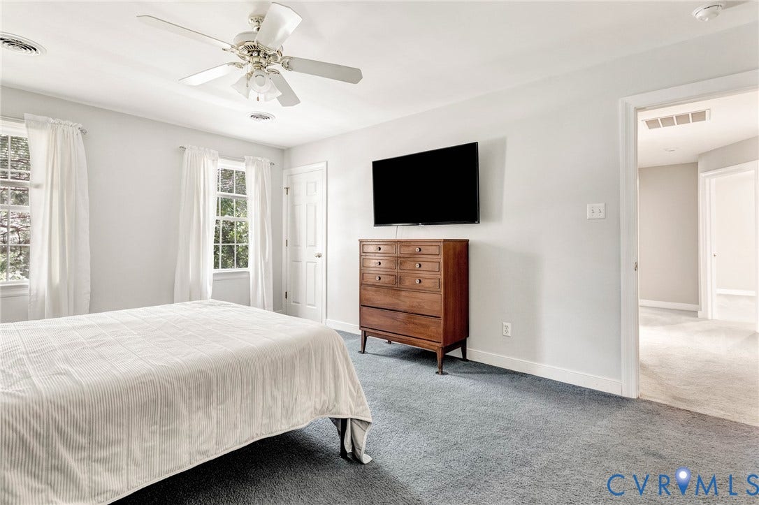 16406 Inchcape Road, Chesterfield, VA 23120 Light gray walls, light gray carpeting, two windows, and a ceiling fan with integrated lighting