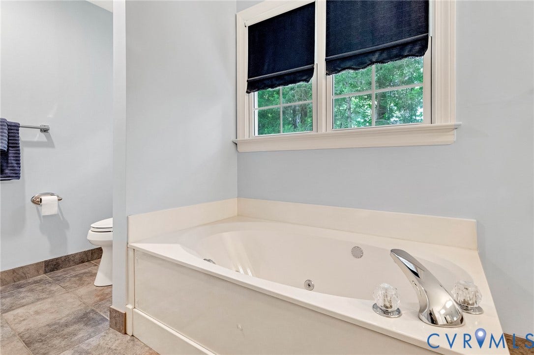 16406 Inchcape Road, Chesterfield, VA 23120 Built-in jetted tub with chrome fixtures, tiled flooring, and a window with white trim