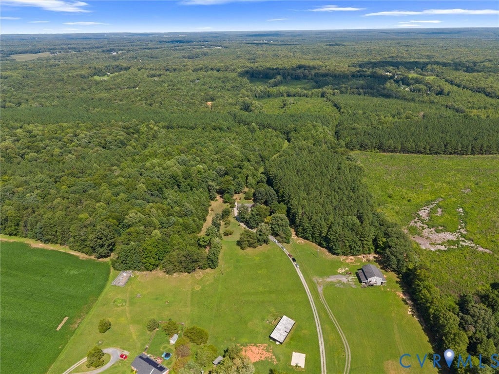 4554 Powhatan Lakes Road, Powhatan, VA 23139 Expansive rural property offering verdant grounds with mature tree coverage, multiple outbuildings, and direct road access