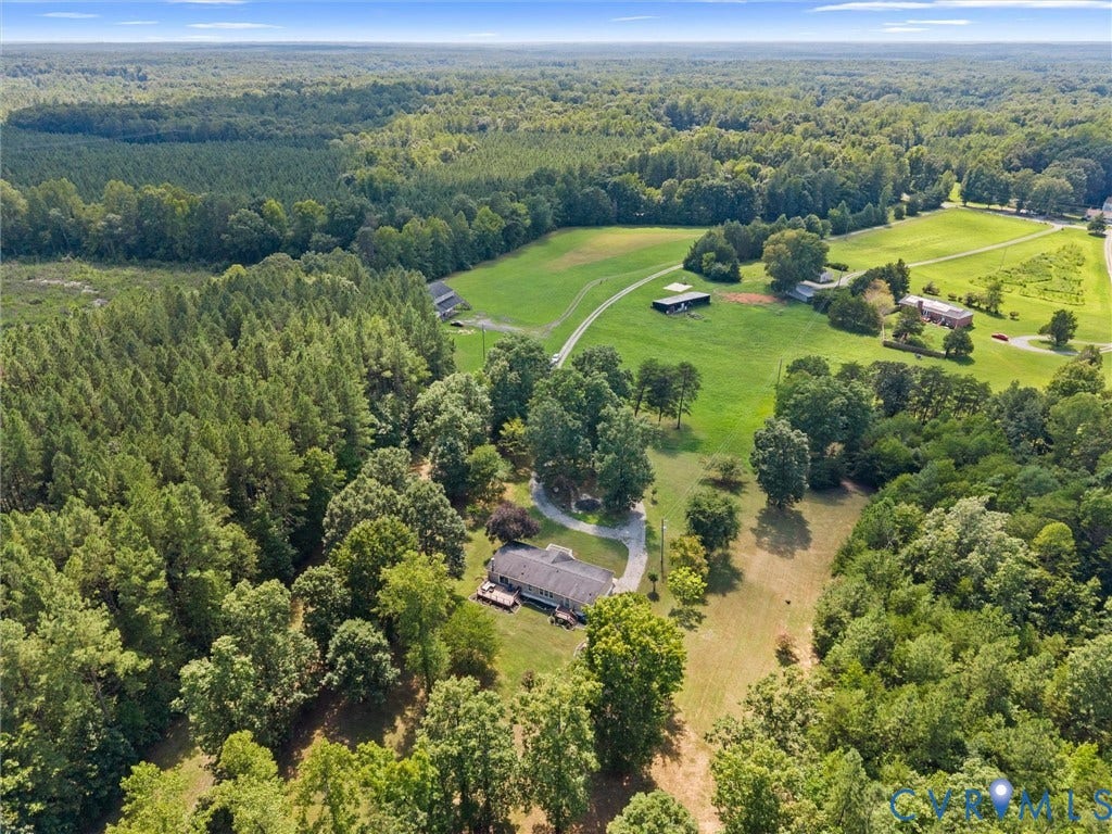 4554 Powhatan Lakes Road, Powhatan, VA 23139 Scenic acreage featuring mature tree-lined boundaries, open pastureland, and a residence situated along a meandering creek