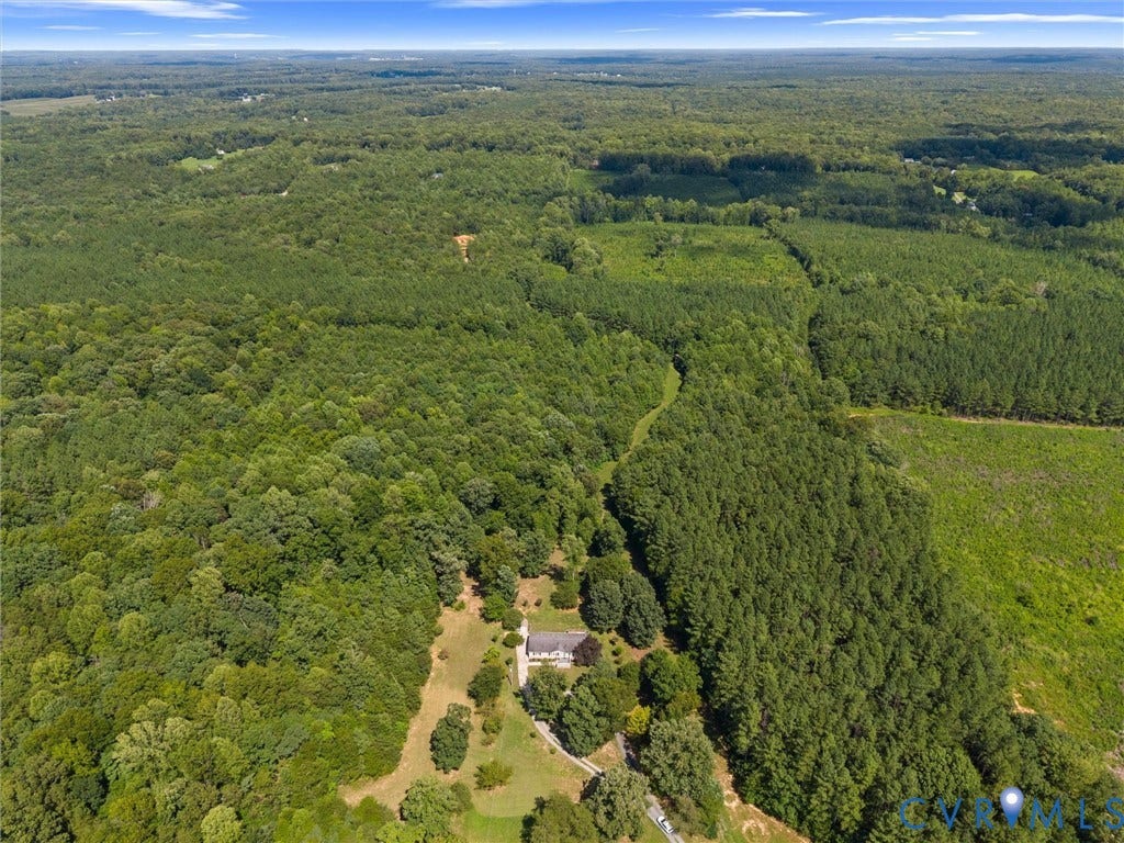 4554 Powhatan Lakes Road, Powhatan, VA 23139 Expansive rural property set on substantial wooded acreage with mature forest coverage and cleared grounds surrounding a residence