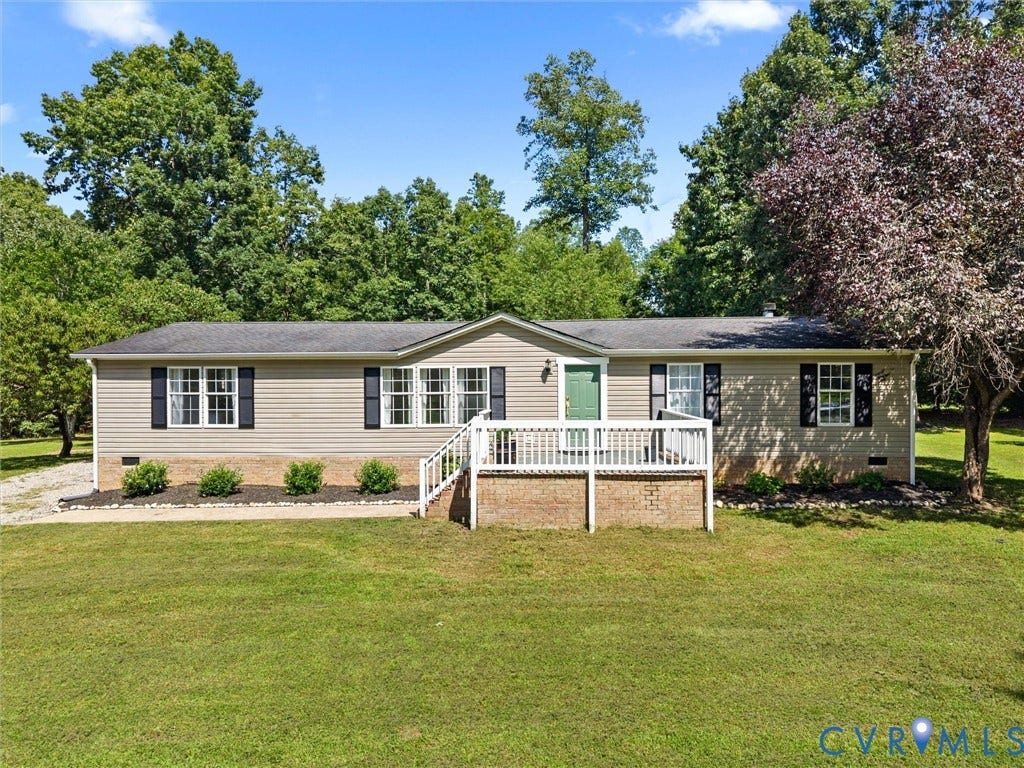 4554 Powhatan Lakes Road, Powhatan, VA 23139 Charming single-story residence featuring vinyl siding and brick foundation, set on expansive manicured grounds with mature landscape trees