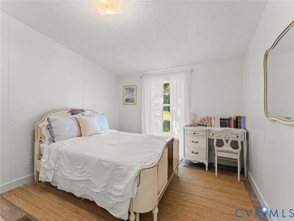4554 Powhatan Lakes Road, Powhatan, VA 23139 White wall paneling with a textured ceiling and a flush mount light fixture