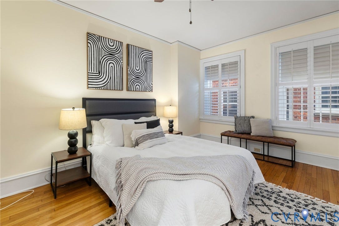 Hardwood flooring, crown molding, and two windows with plantation shutters