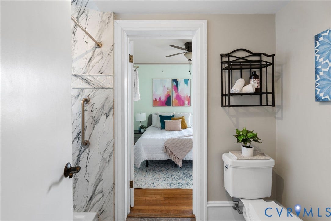 White toilet with wall-mounted shelving