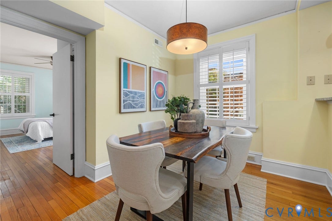 Hardwood flooring, crown molding, white window shutters, and a drum pendant light fixture