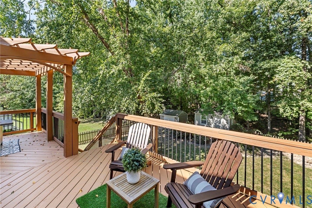 2308 Strangford Court, Henrico, VA 23233 Expansive outdoor deck with a pergola, wood railing with black balusters, and a backyard with mature trees