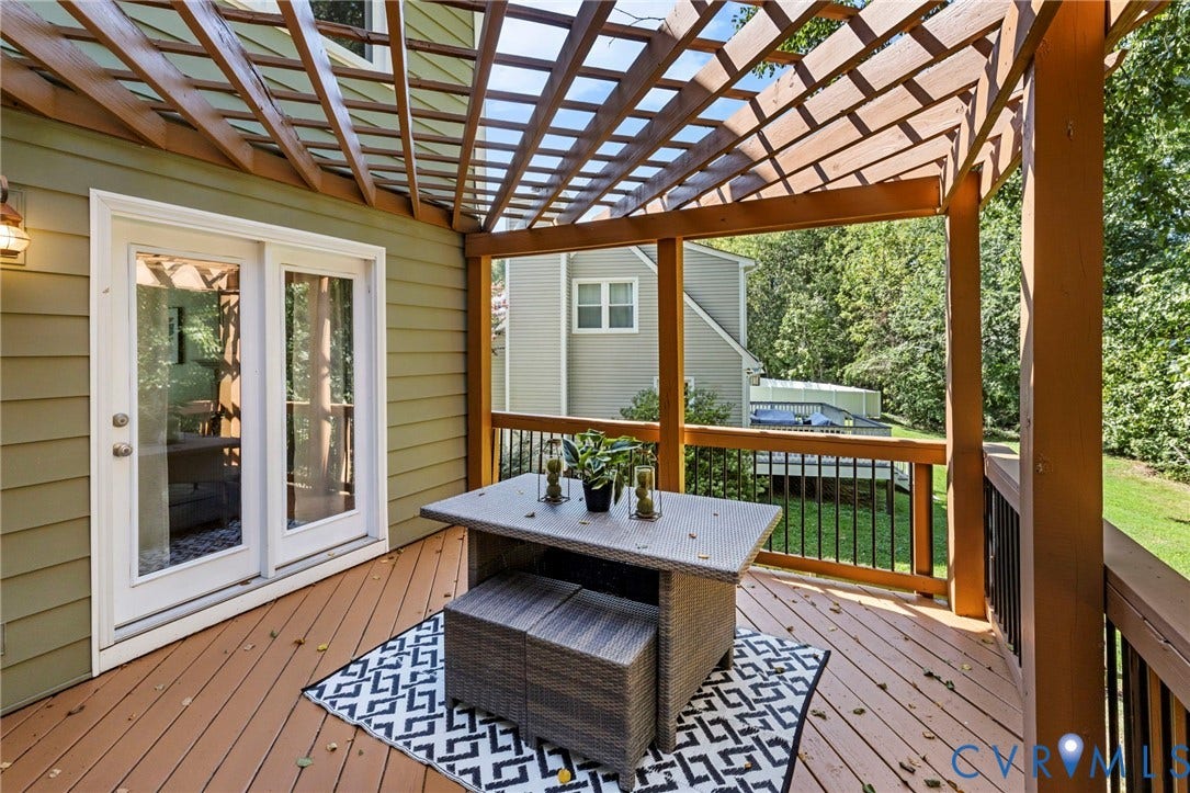 2308 Strangford Court, Henrico, VA 23233 Expansive outdoor deck featuring wood-finish flooring, a decorative wood pergola, and metal railings