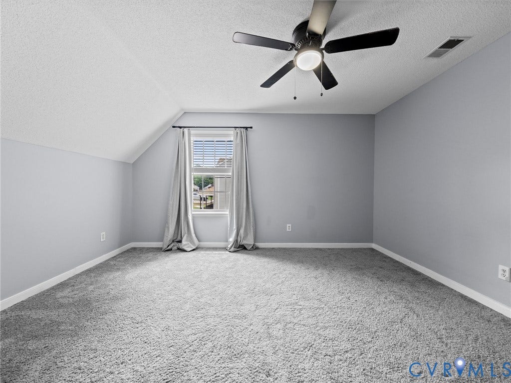 6712 N Hedges Road, Chesterfield, VA 23224 Spacious room featuring sloped ceilings, light gray wall paint, and gray shag carpeting