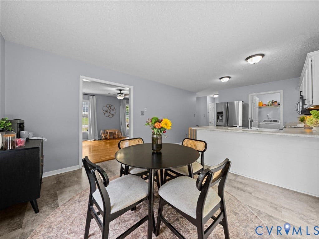 6712 N Hedges Road, Chesterfield, VA 23224 Kitchen with a breakfast bar, stainless steel refrigerator, white cabinetry, and recessed lighting