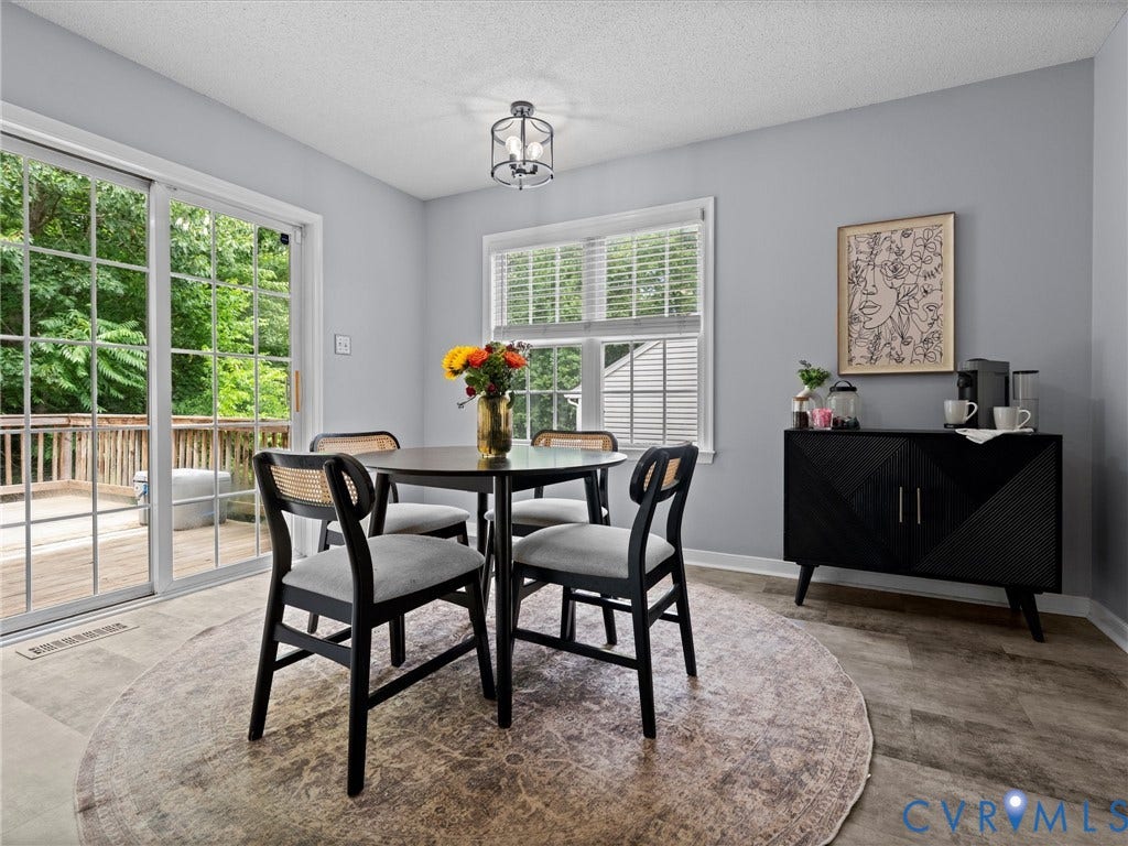 6712 N Hedges Road, Chesterfield, VA 23224 Dining area featuring light gray walls and wood-finish flooring