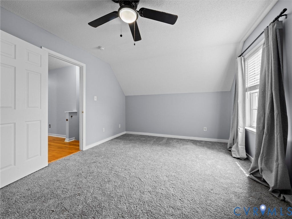 6712 N Hedges Road, Chesterfield, VA 23224 Room featuring sloped ceilings, a ceiling fan with integrated lighting, and a window with blinds