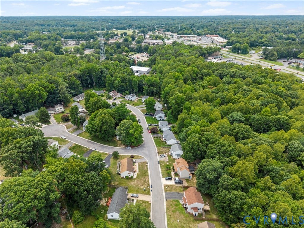6712 N Hedges Road, Chesterfield, VA 23224 Aerial perspective showcasing a residential street with single-story homes, surrounded by dense mature trees