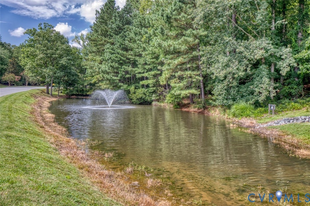 6311 Chiswick Park, Williamsburg, VA 23188 Serene pond setting with aerating fountain, mature tree-lined perimeter, and manicured lawn