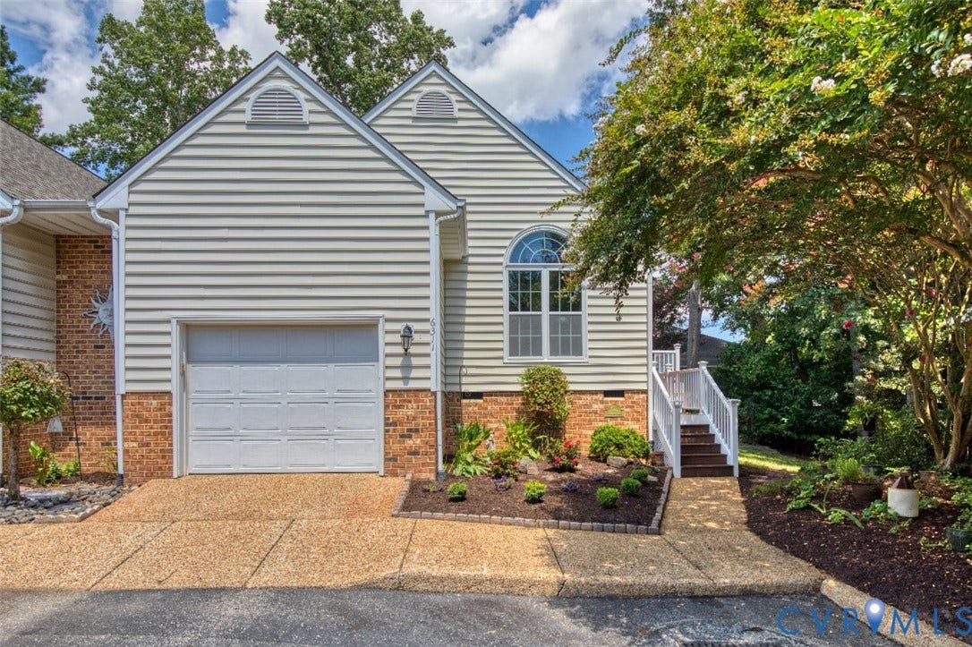 6311 Chiswick Park, Williamsburg, VA 23188 Charming residence showcasing a brick and horizontal siding exterior with a two-car garage featuring a white panel door