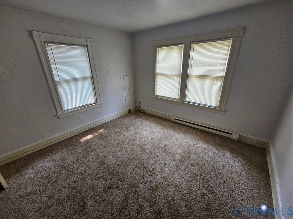 1601 Byron Street, Henrico, VA 23222 Bright corner bedroom with dual windows providing natural light, neutral wall finishes, and carpet flooring throughout