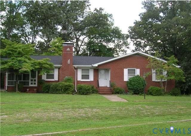8301 Hickory Road, South Chesterfield, VA 23803 Brick exterior with white window shutters, a prominent brick chimney, and a screened-in porch