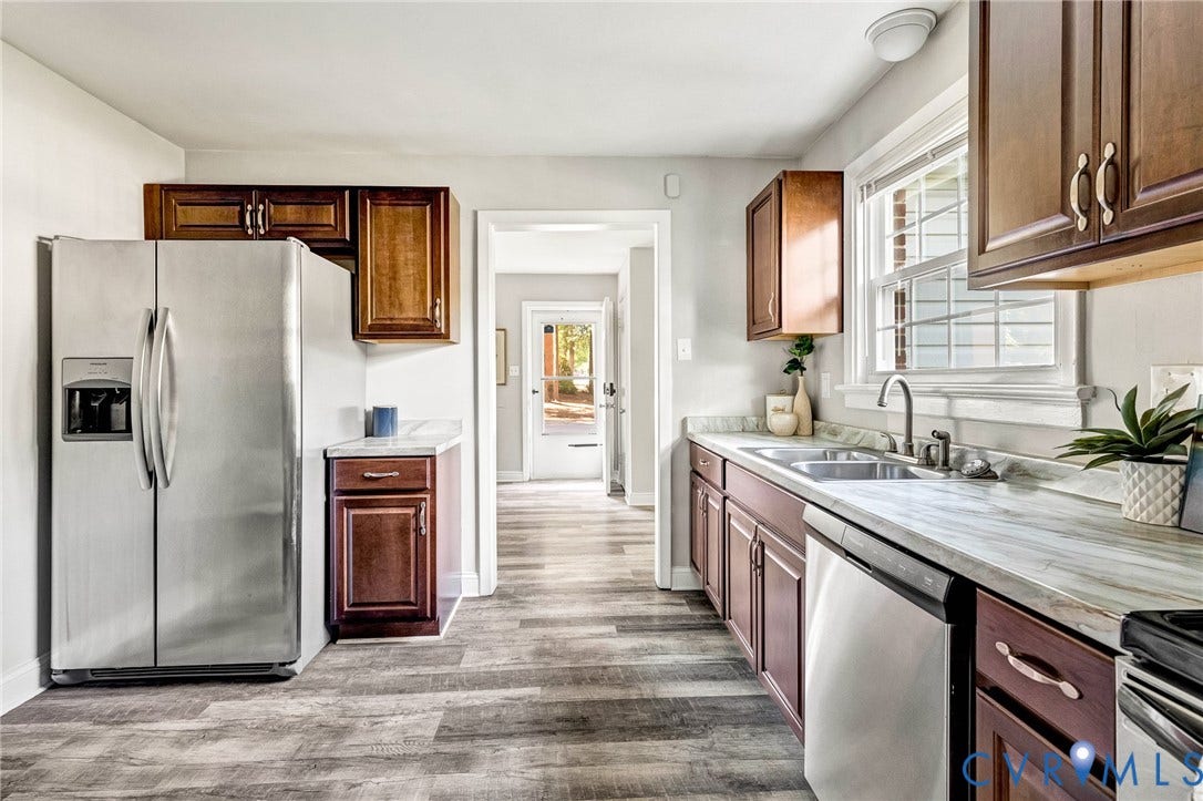 2807 Rothland Drive, Henrico, VA 23294 Kitchen featuring wood-finish flooring, stainless steel appliances, dark wood cabinetry, white countertops, and a double-basin sink