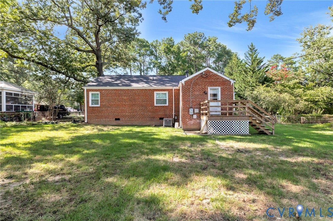 2807 Rothland Drive, Henrico, VA 23294 Brick exterior with a wood deck and staircase, featuring a screened porch and mature trees