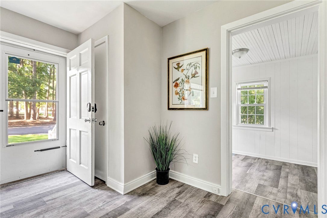 2807 Rothland Drive, Henrico, VA 23294 Wood-finish flooring throughout, white paneled door, and neutral wall paint