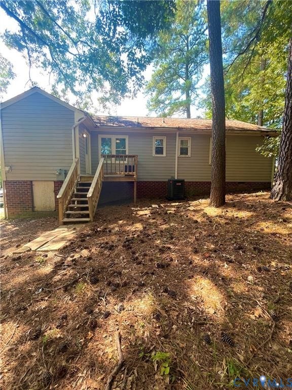 7032 Claybird Lane, Mechanicsville, VA 23111 Rear exterior with light-toned siding and brick foundation
