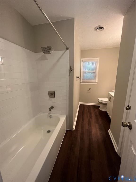 7032 Claybird Lane, Mechanicsville, VA 23111 Bathtub with subway tile surround, rainfall showerhead, and dark wood-finish flooring