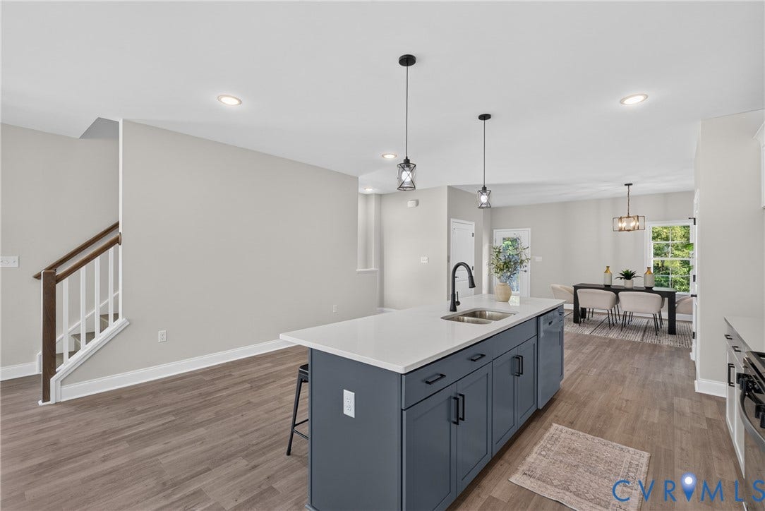 6537 Hardee Haven Place, Midlothian, VA 23112 Kitchen island with a white countertop and dark cabinetry, stainless steel sink with a matte black faucet, wood-finish flooring, and recessed ceiling lighting