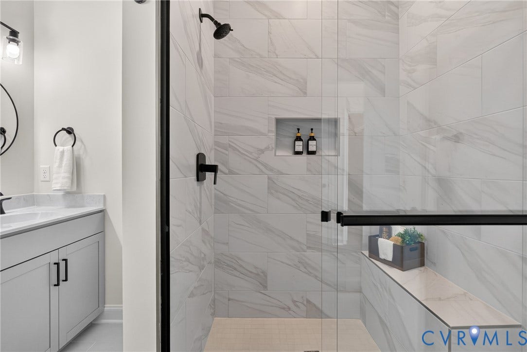 6537 Hardee Haven Place, Midlothian, VA 23112 Walk-in shower with large format wall tiling, built-in shelving, and a shower bench