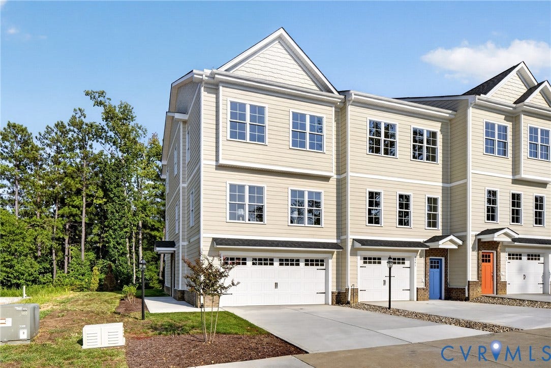 6537 Hardee Haven Place, Midlothian, VA 23112 Multi-level townhome featuring light-colored siding, multiple windows, an attached garage, a paved driveway, and mature landscaping