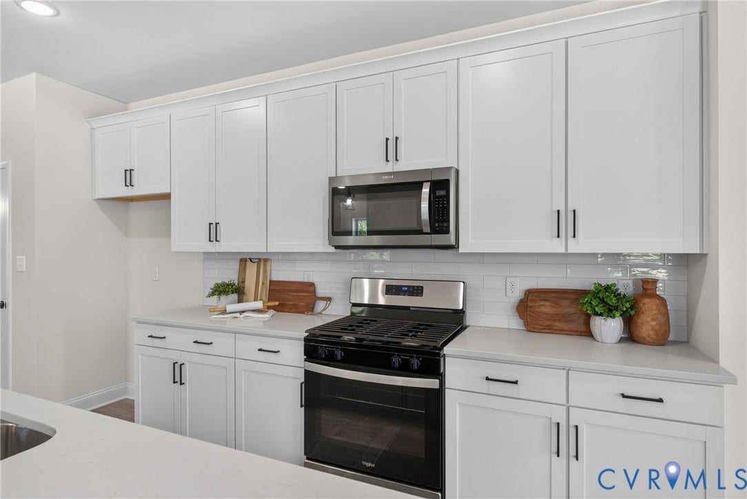 6537 Hardee Haven Place, Midlothian, VA 23112 White shaker-style cabinetry with matte black hardware, stainless steel microwave, gas range with oven, light-toned countertop, and white subway tile backsplash