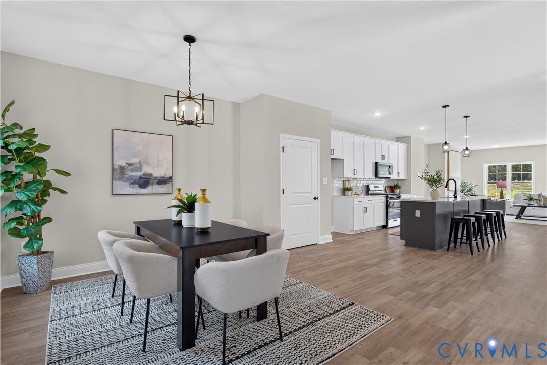 6537 Hardee Haven Place, Midlothian, VA 23112 Expansive wood-finish flooring throughout, modern kitchen island with seating, white shaker cabinetry, stainless steel appliances, and a contemporary dining room chandelier