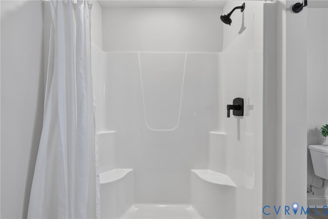 6537 Hardee Haven Place, Midlothian, VA 23112 Shower featuring matte black fixtures and built-in shelving