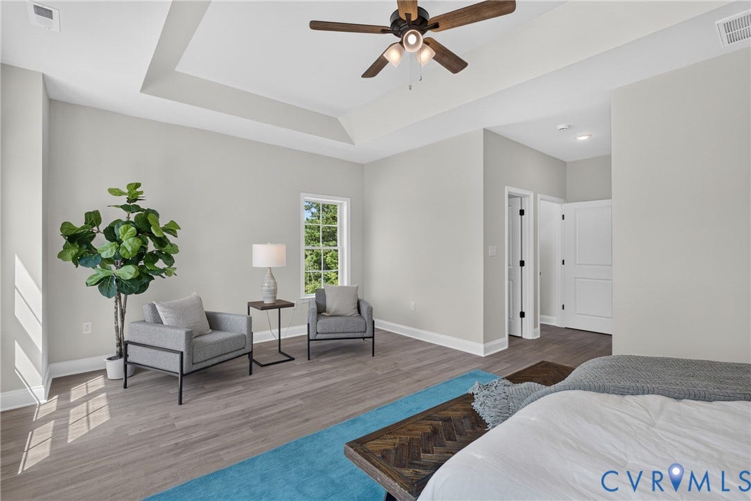6537 Hardee Haven Place, Midlothian, VA 23112 Tray ceiling with a ceiling fan, wood-finish flooring, white trim, and a window
