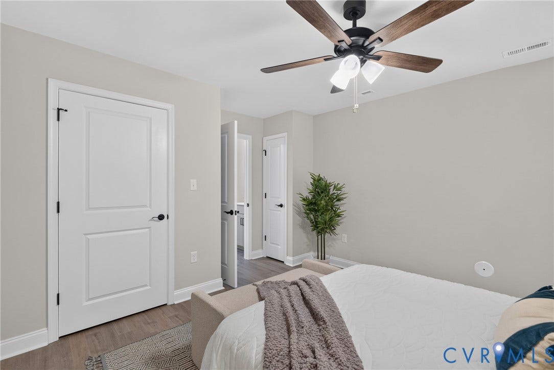 6537 Hardee Haven Place, Midlothian, VA 23112 Wood-finish flooring, white panel doors with matte black hardware, and a ceiling fan with integrated lighting