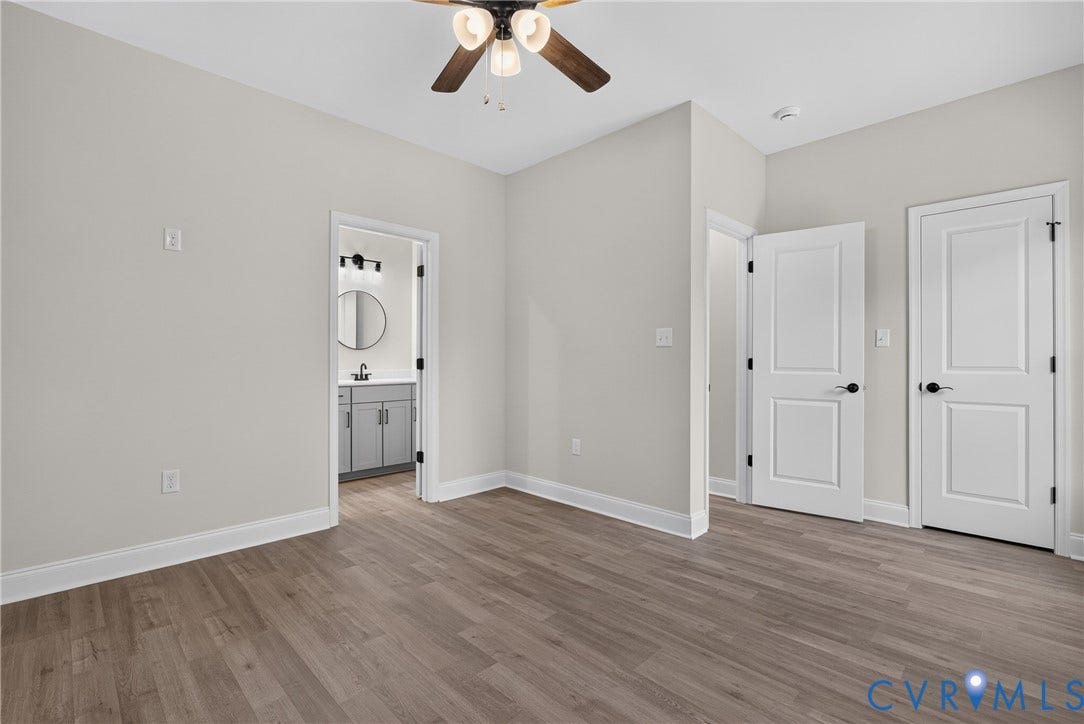 6537 Hardee Haven Place, Midlothian, VA 23112 Wood-finish flooring, white paneled doors with matte black hardware, and a ceiling fan with light fixture