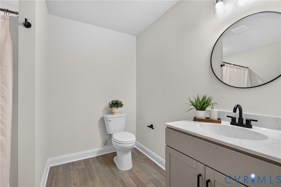 6537 Hardee Haven Place, Midlothian, VA 23112 Wood-finish flooring, white walls, and a white toilet