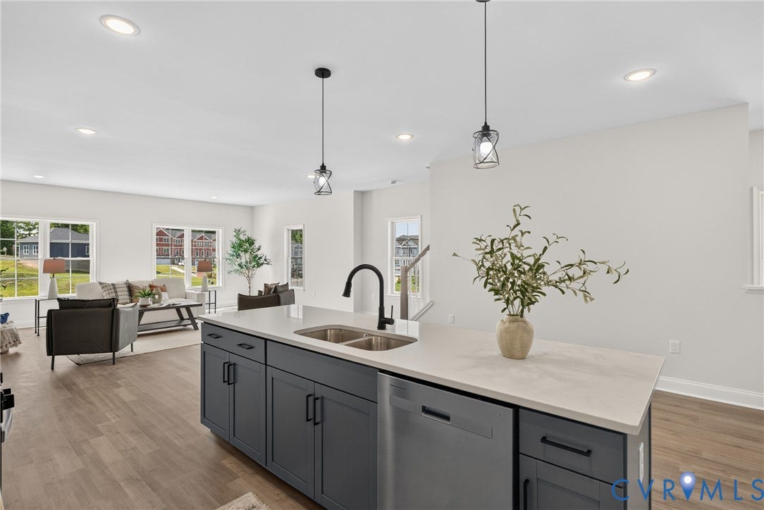 6537 Hardee Haven Place, Midlothian, VA 23112 Kitchen island featuring dark cabinetry, stainless steel dishwasher, and dual basin sink with a matte black faucet