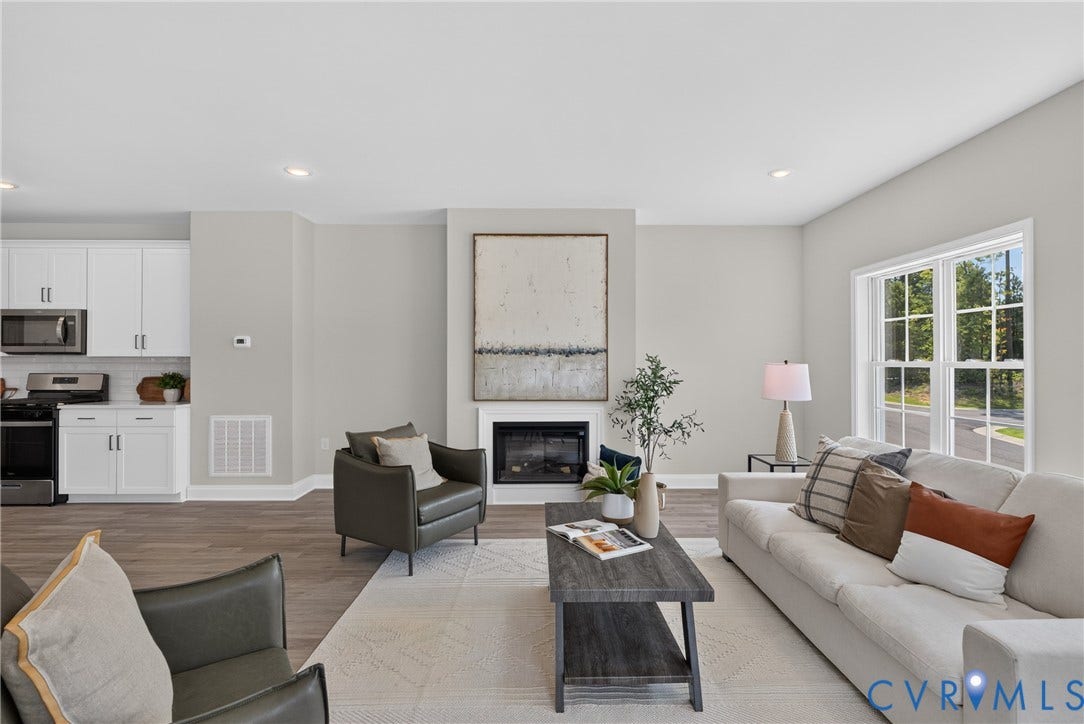 6537 Hardee Haven Place, Midlothian, VA 23112 Open-concept living area featuring wood-finish flooring, recessed lighting, a built-in fireplace, and a large multi-pane window