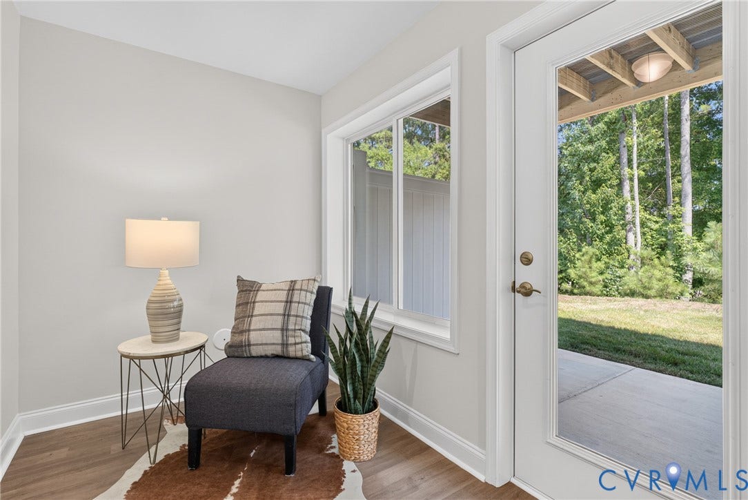 6537 Hardee Haven Place, Midlothian, VA 23112 Light gray wall paint, wood-finish flooring, white trim, sliding window, and a full-light glass door leading to an outdoor patio