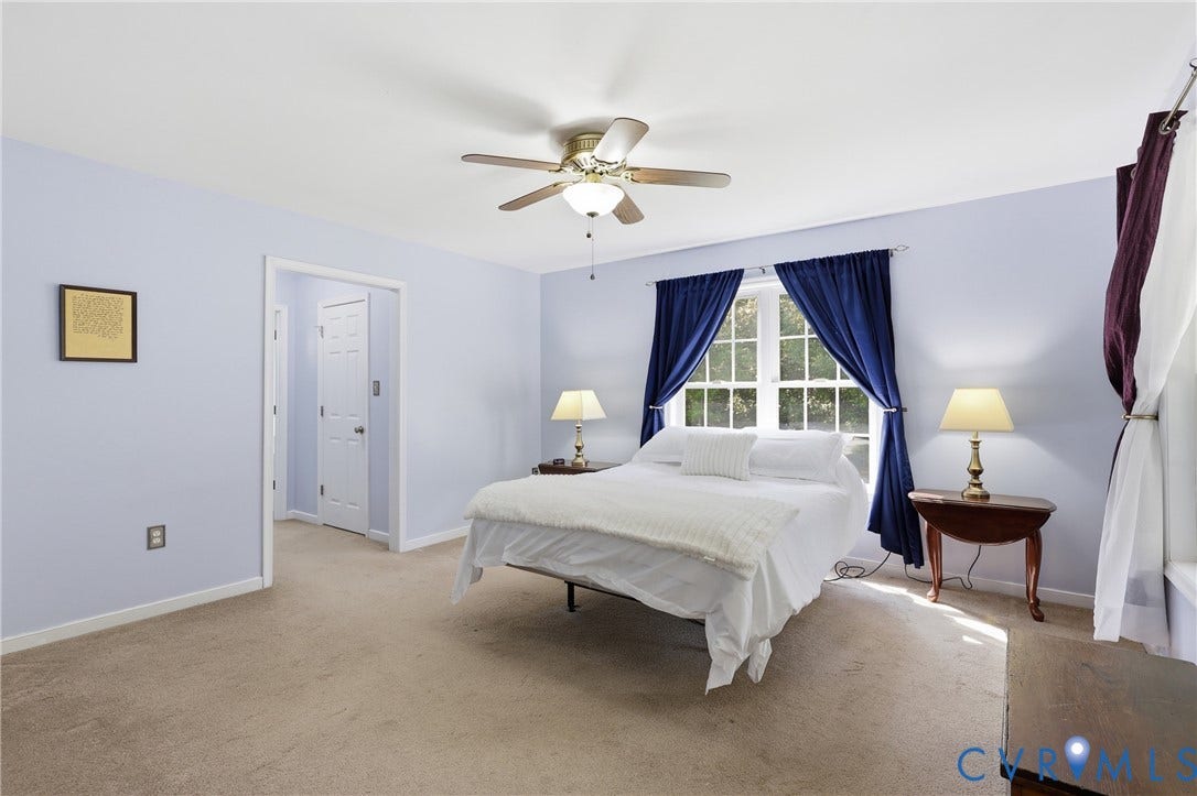 5295 Chimney Springs Drive, Saunders Acres, Goochland, VA 23063 Carpeted flooring with light blue wall paint, a ceiling fan, and a window with white trim