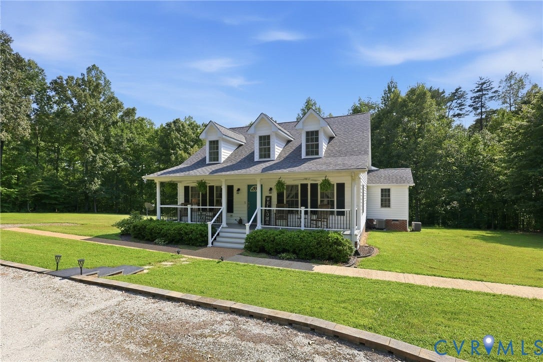 5295 Chimney Springs Drive, Saunders Acres, Goochland, VA 23063 White siding exterior with a covered front porch featuring white railings